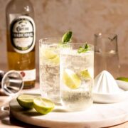 Two highball glasses of tequila and sprite sitting on a marble tray.