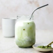 An iced vanilla matcha latte served in a mason jar.