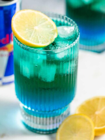 A glass of Irish Trash Can drink topped with a lemon slice.