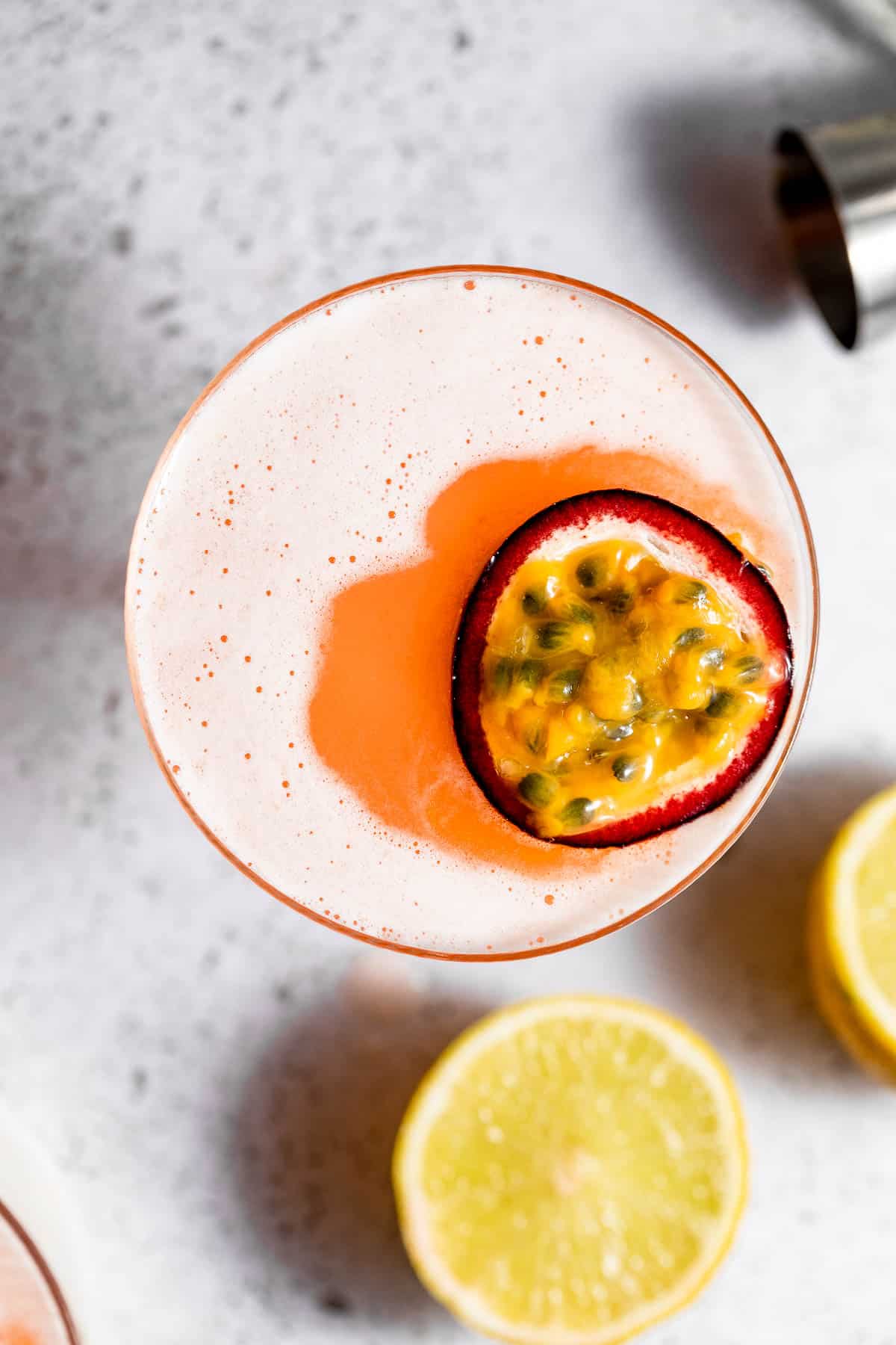 A pornstar martini garnished with a half passion fruit. 