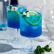 Two blue motorcycle drinks sitting on a counter.