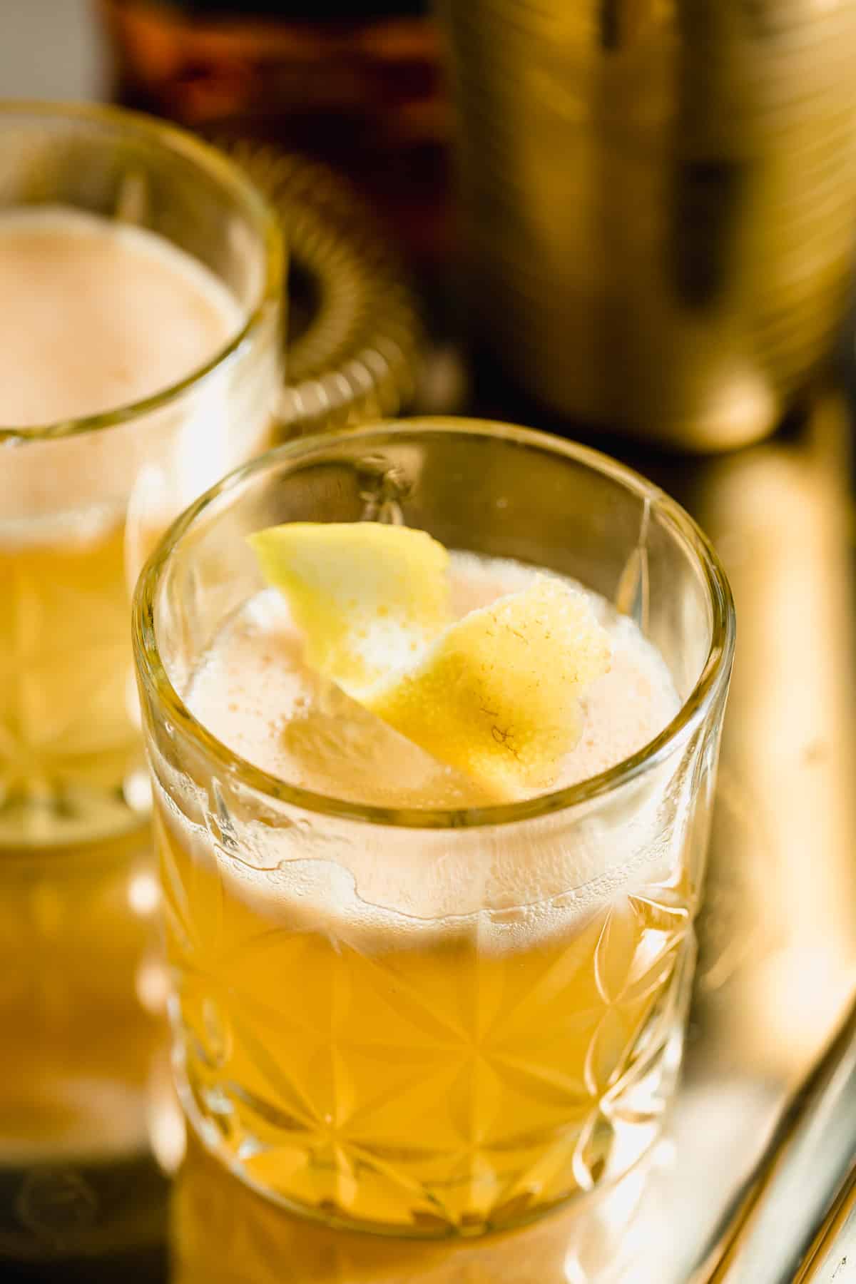 A gold rush cocktail in a serving glass.