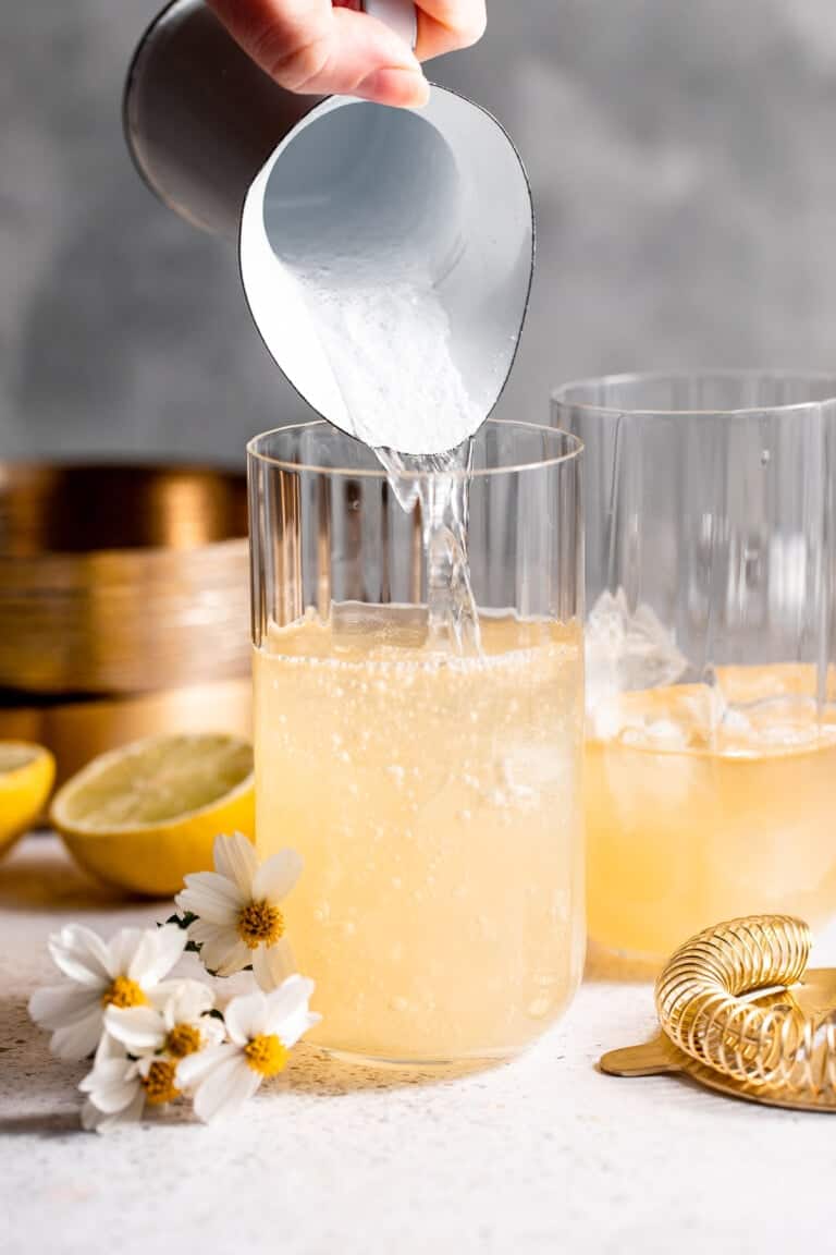 Lemon lime soda being poured into a glass of Lynchburg lemonade.