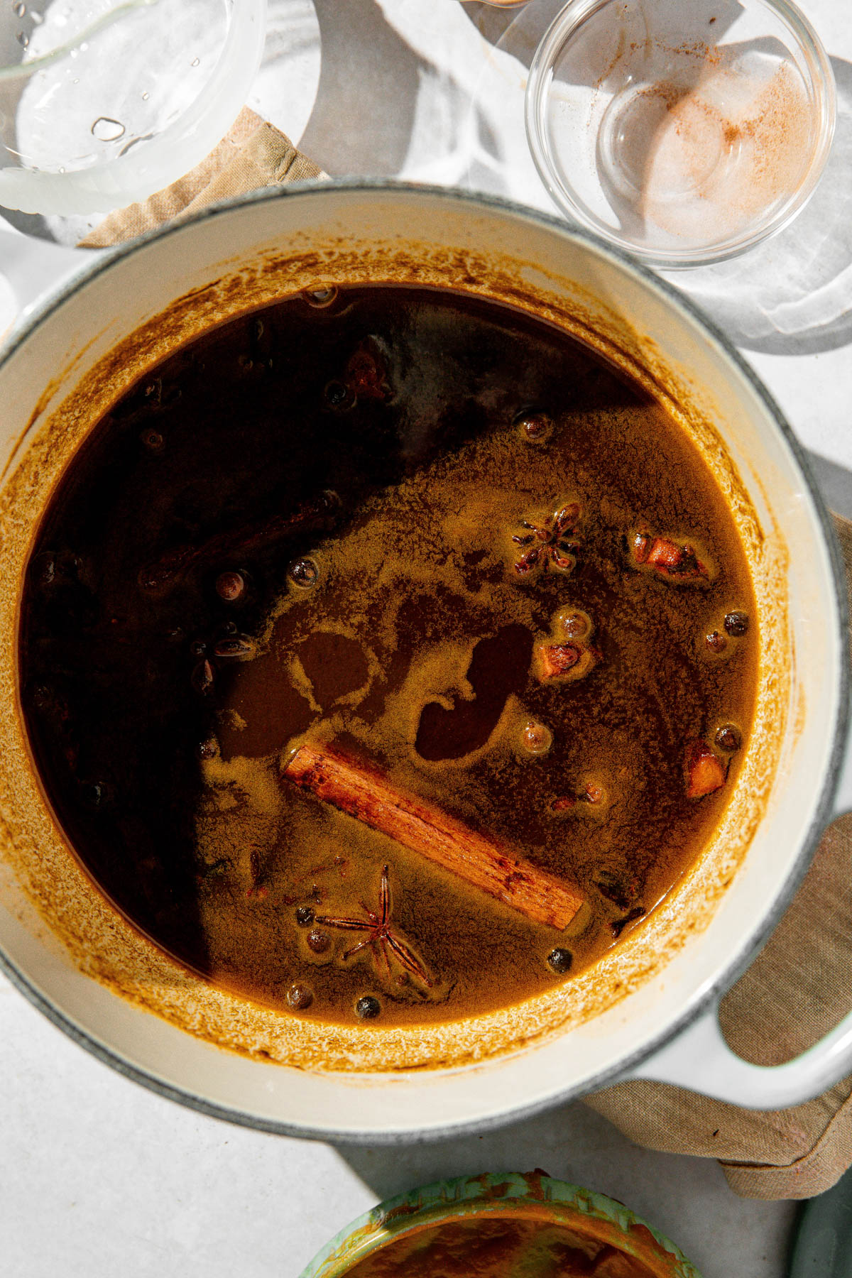 A enamel pot containing all of the pumpkin spice syrup ingredients being cooked together.