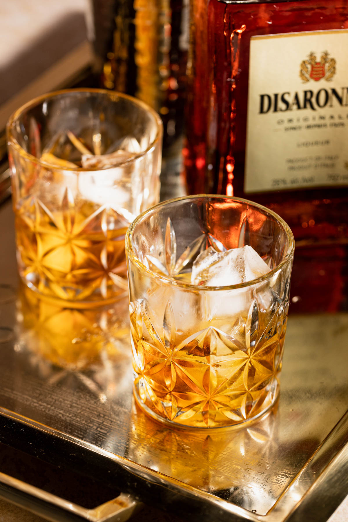 Two French Connection cocktails served in rocks glasses sitting on a metal tray.