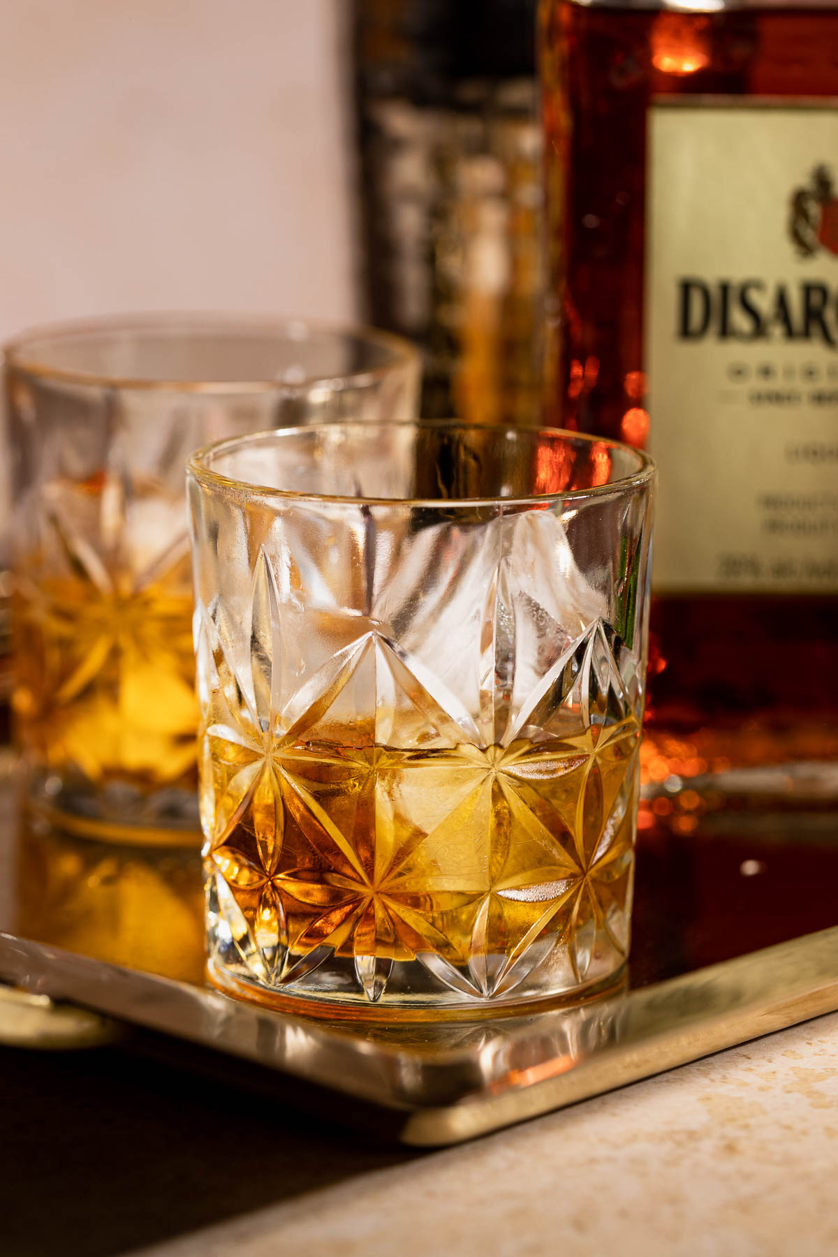 A French connection cocktail sitting on a metal tray.