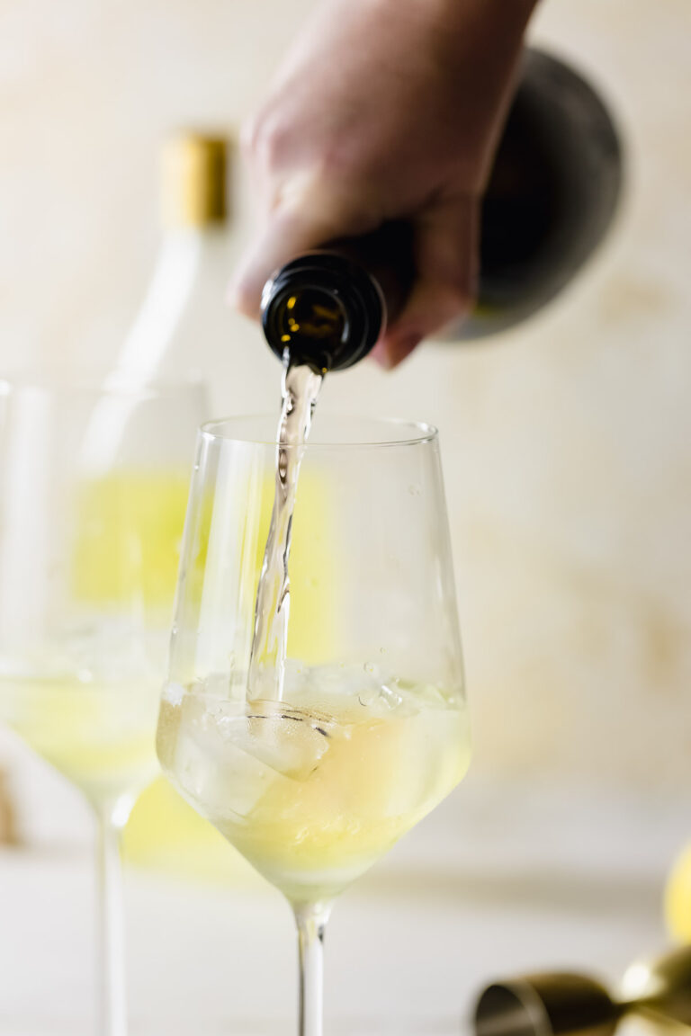 Prosecco being poured into a wine glass.